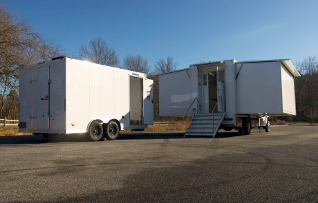 Expandable mobile laboratory truck deployed in a rural field environment with extended workspace for field testing and diagnostics.