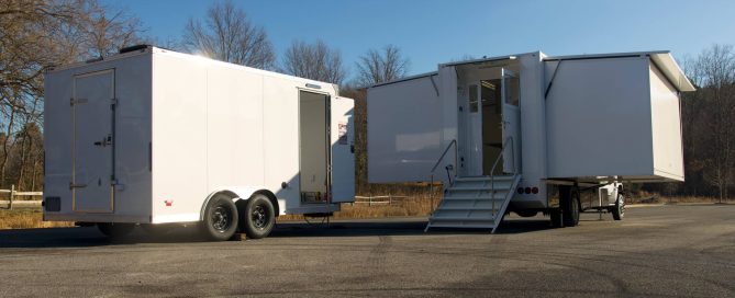 Expandable mobile laboratory truck deployed in a rural field environment with extended workspace for field testing and diagnostics.