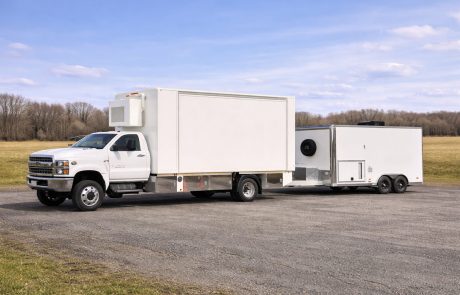 Mobile laboratory truck with auxiliary equipment trailer for extended field operations and logistics support.