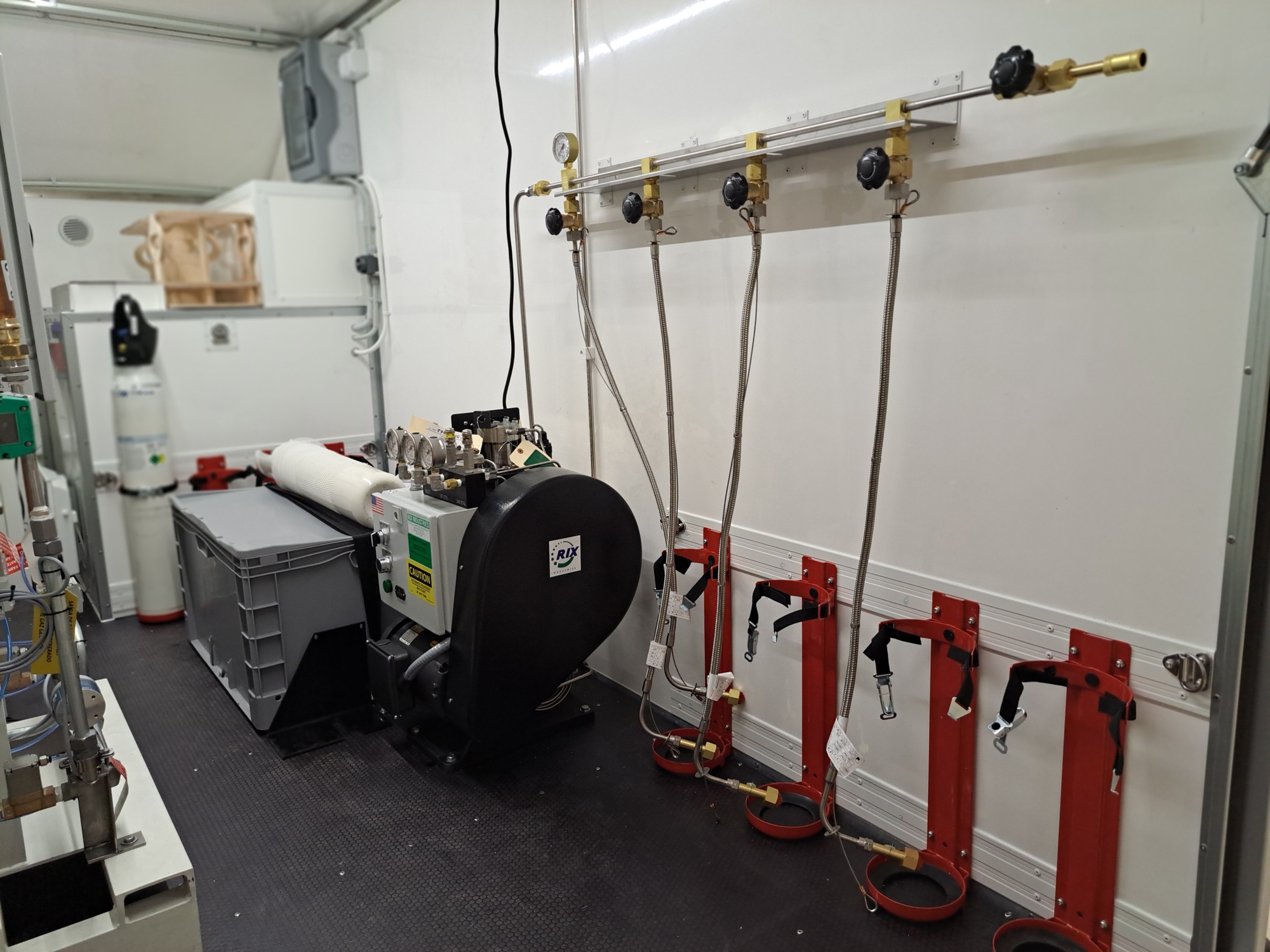 Interior of mobile oxygen generator trailer showing equipment setup for medical oxygen production Interior of mobile oxygen generator trailer showing equipment setup for medical oxygen production